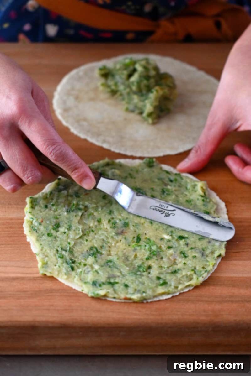 Wholesome Paleo Shrimp Toast 9 An offset metal spatula carefully spreads the raw shrimp paste in a thin, uniform layer over a paleo almond flour tortilla.
