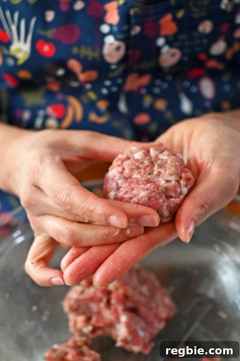 Forming a sausage patty with two hands.