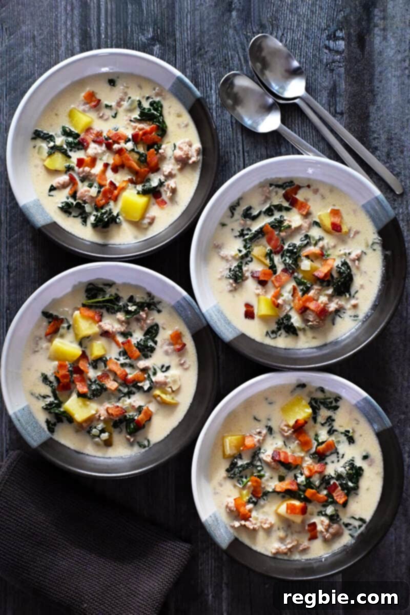 An overhead shot of four bowls of dairy-free Zuppa Toscana.