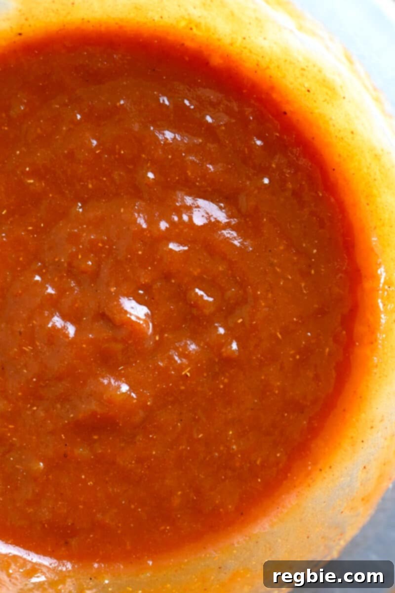 The paleo and gluten-free Char Siu sauce after being whisked until smooth, showcasing its rich red color.