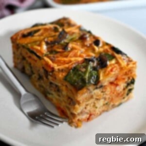 A slice of paleo and Whole30 sausage breakfast casserole on a white plate.