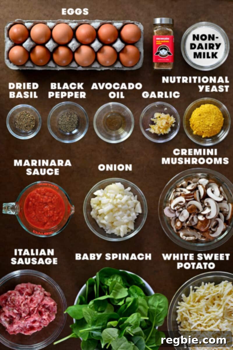A beautifully arranged overhead view of all the raw ingredients, perfectly measured and ready to be transformed into a paleo and Whole30 sausage breakfast casserole.