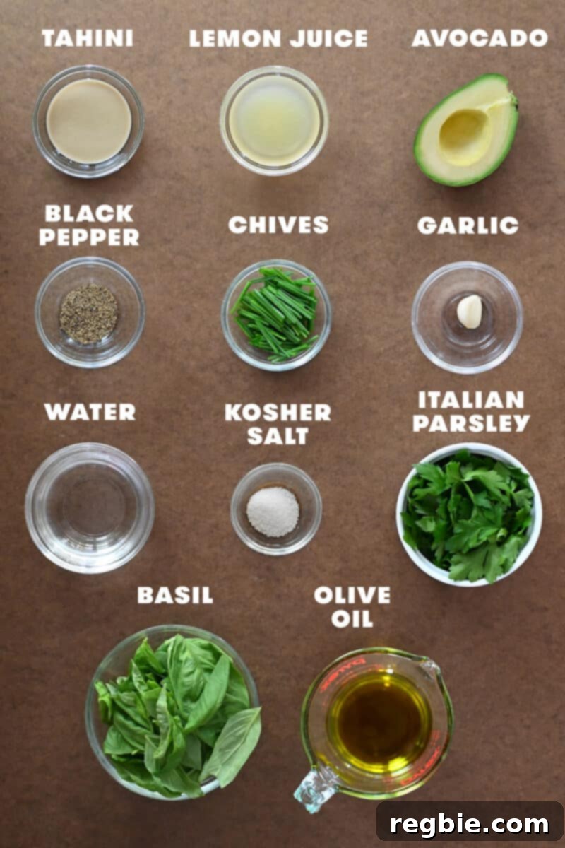 An overhead shot showcasing the fresh, raw ingredients laid out to make paleo, dairy-free, vegan, and Whole30 Green Goddess Dressing.