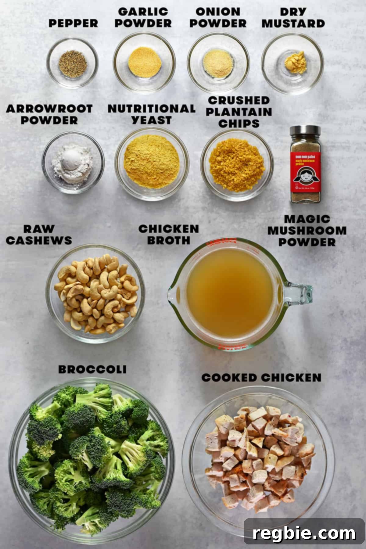An overhead shot of the raw ingredients laid out to make paleo and Whole30 Chicken Divan, including broccoli, cashews, chicken, and various spices.