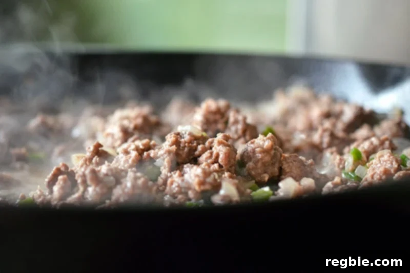 Aromatic Keema Samosa Platter 10 Cooked ground beef in a pan, broken into small pieces and browned, ready for spices in the paleo deconstructed samosa recipe.