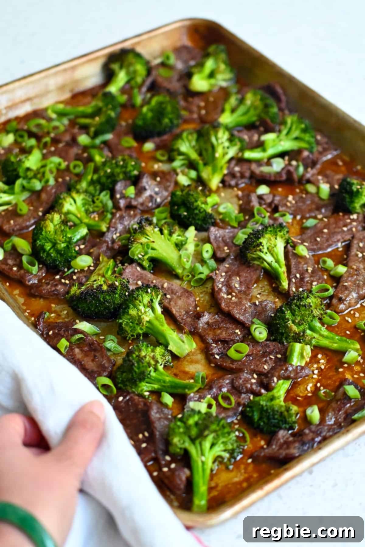 A side view of a ready-to-serve sheet pan beef and broccoli, showcasing its delicious texture and inviting presentation.