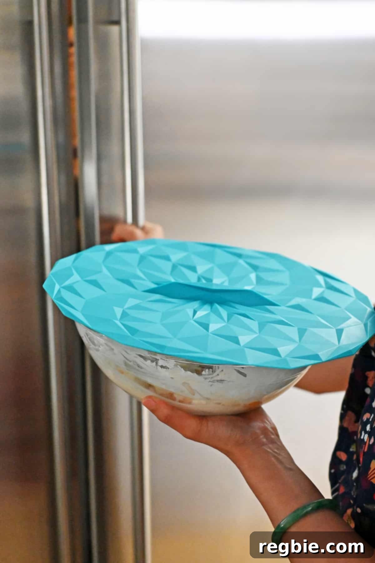 The process of placing a covered bowl of ambrosia salad into the refrigerator to chill thoroughly before serving.