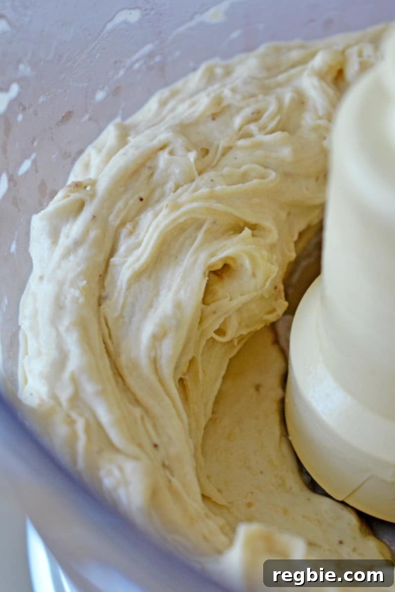 Guilt-Free Chunky Monkey Nice Cream Bonbons 6 A pristine food processor bowl filled to the brim with beautifully smooth and creamy banana nice cream, ready for its first freeze.