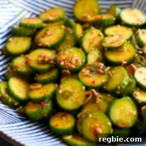 An closeup shot of a blue and white serving bowl with paleo and gluten free Korean cucumber salad.