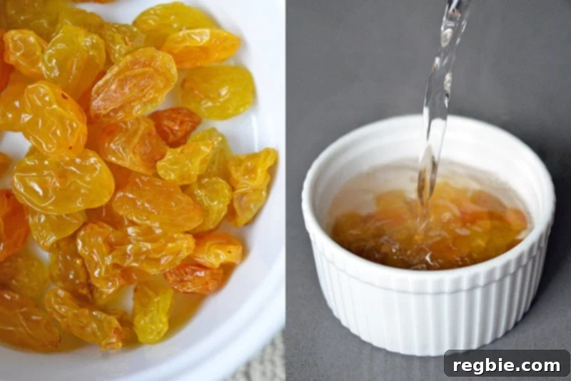 Golden raisins are soaking in a small white bowl, absorbing hot water to become plump and tender for the salad.