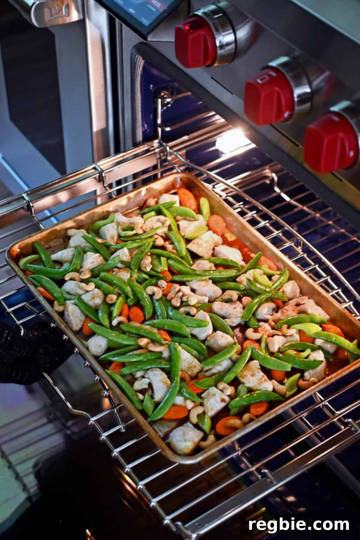 Sheet Pan Cashew Chicken: Paleo & Whole30 Perfection 15 A sheet pan brimming with cashew chicken ingredients is carefully slid back into the oven, poised for a few minutes of intense broiling.
