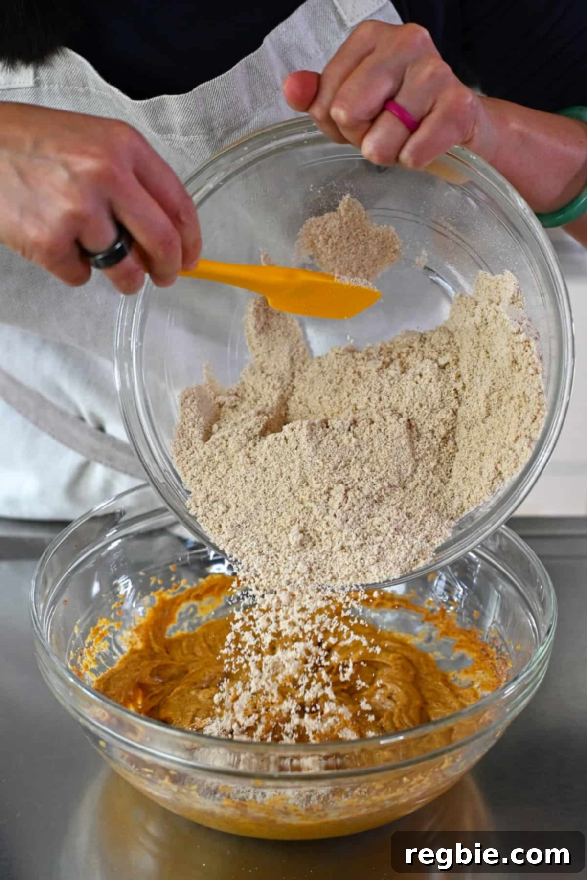 Paleo Pumpkin Bliss Cookies 12 Adding the almond flour mixture to the bowl of wet ingredients to make paleo and gluten free pumpkin cookies.