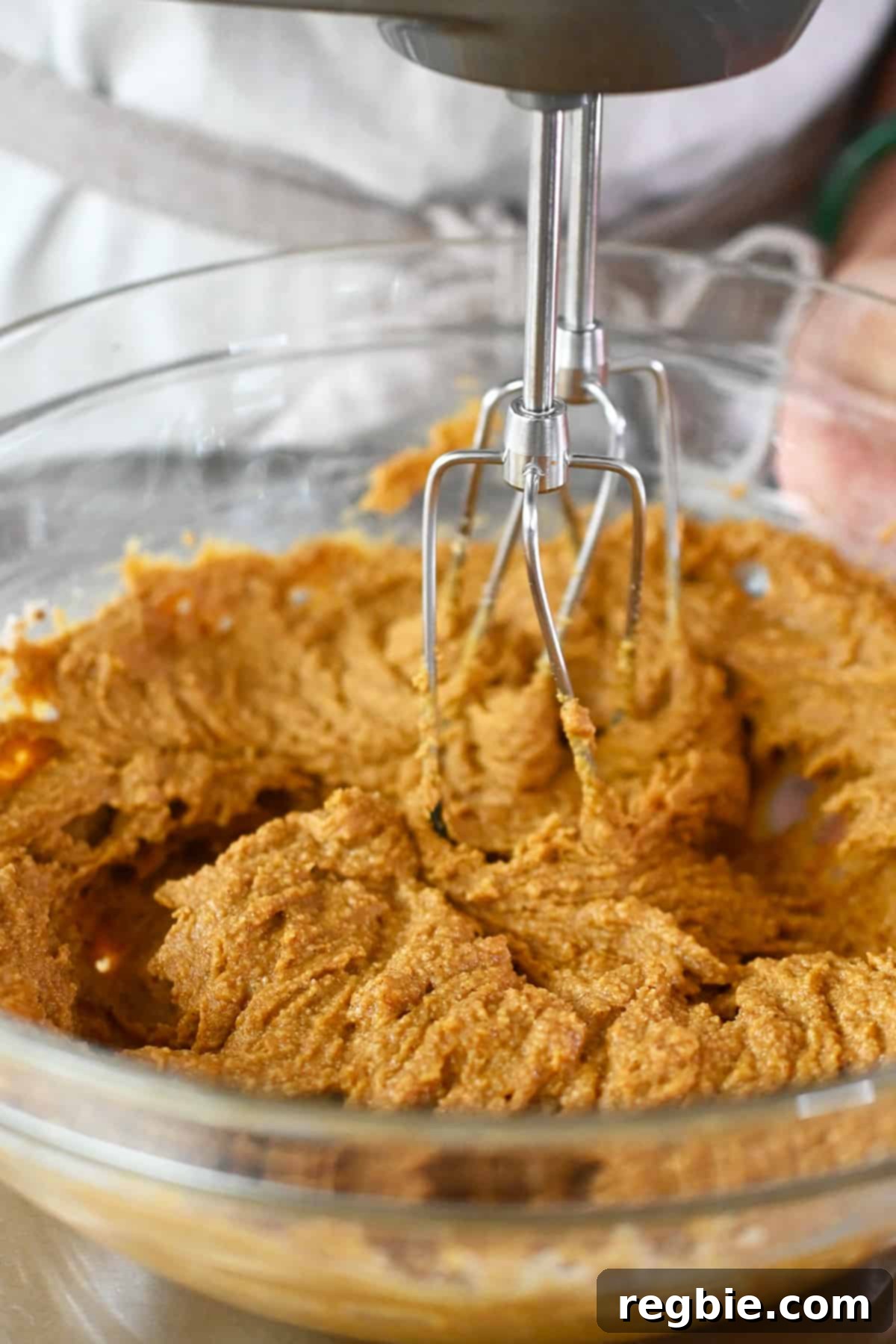 Paleo Pumpkin Bliss Cookies 13 A closeup photo showing a hand mixer blending the batter to make paleo pumpkin cookies.