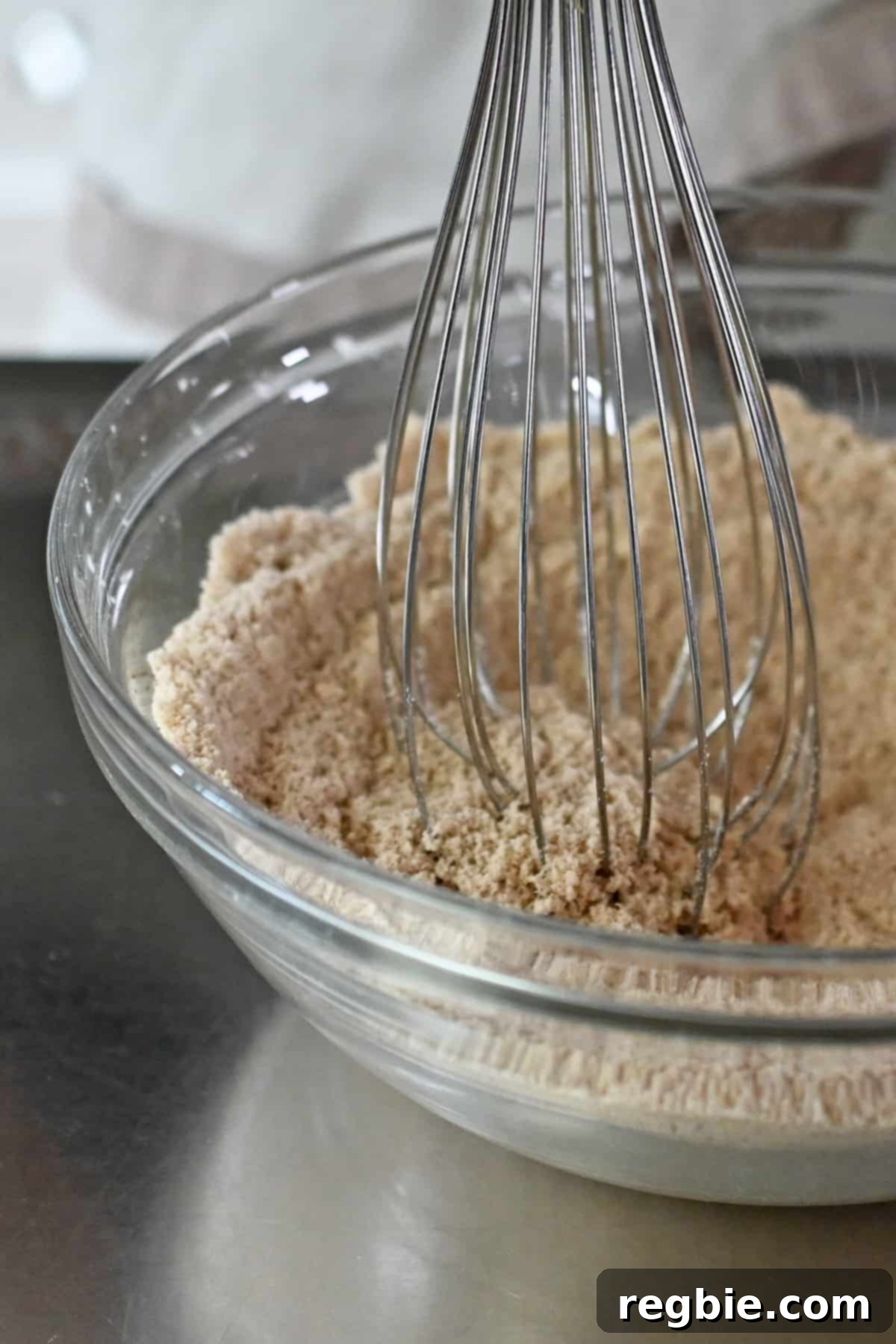 Paleo Pumpkin Bliss Cookies 8 A closeup of a metal balloon whisk mixing the dry ingredients to make paleo pumpkin cookies.