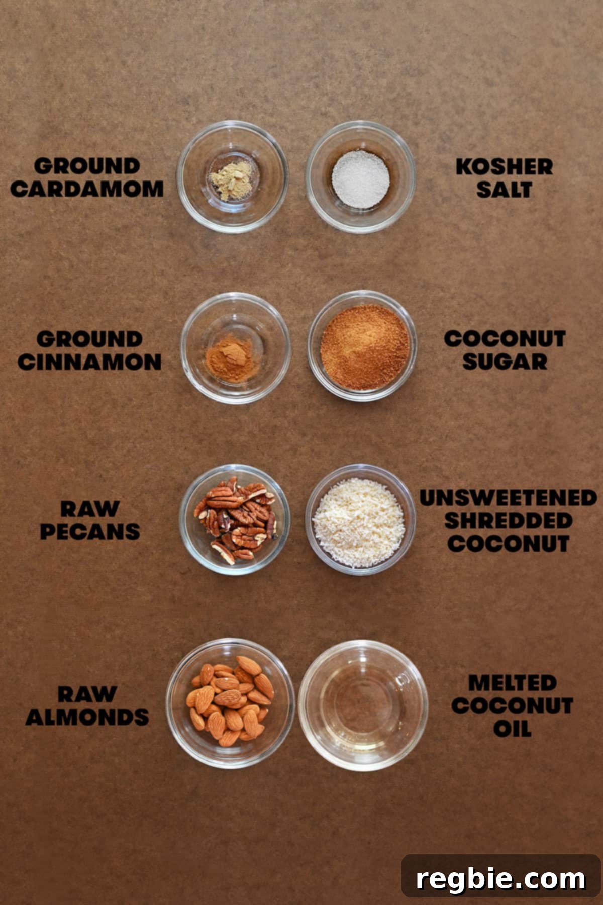 An overhead shot of the raw ingredients for the paleo toppings for apple muffins measured out in glass bowls, including nuts, coconut flakes, and coconut sugar.