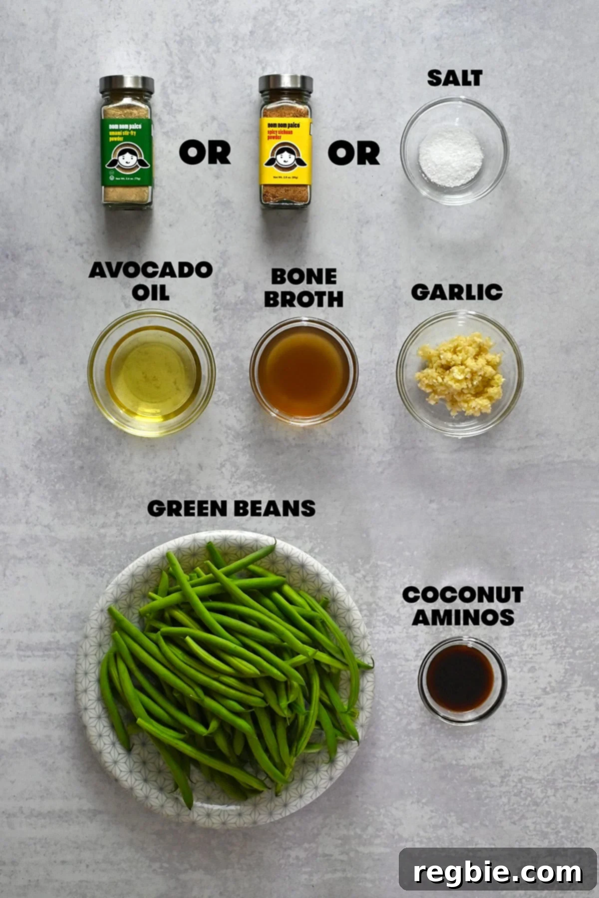 Raw ingredients laid out for making Chinese garlic green beans, including fresh green beans, garlic, and seasoning containers.