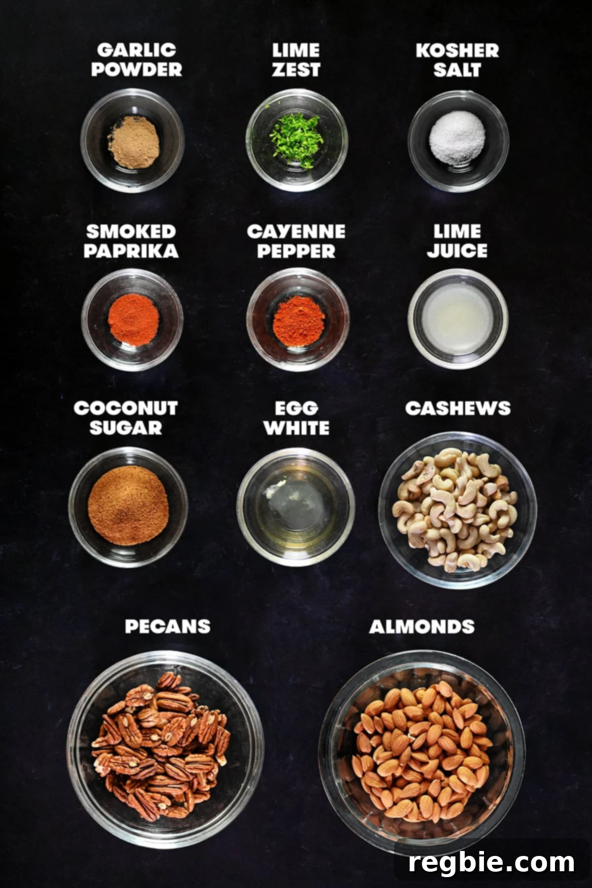 A vibrant flat lay photo showcasing all the measured and labeled raw ingredients required to make delicious paleo spiced nuts, neatly arranged for preparation.