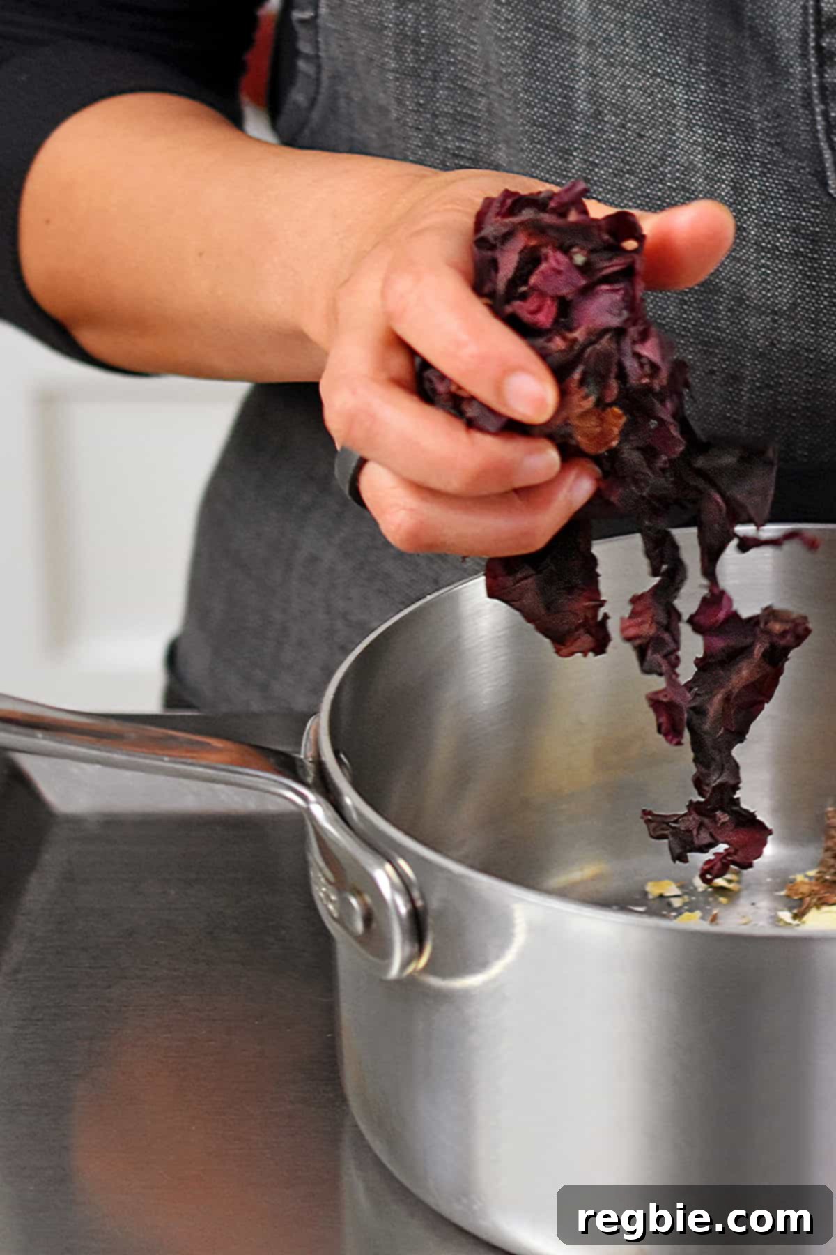Oceanic Savory Drip 6 Adding a handful of dried dulse into a small saucepan to make vegan fish sauce.