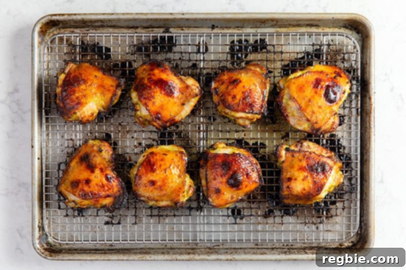 An overhead shot of the gluten-free Asian Chicken thighs out of the oven with golden brown skin.