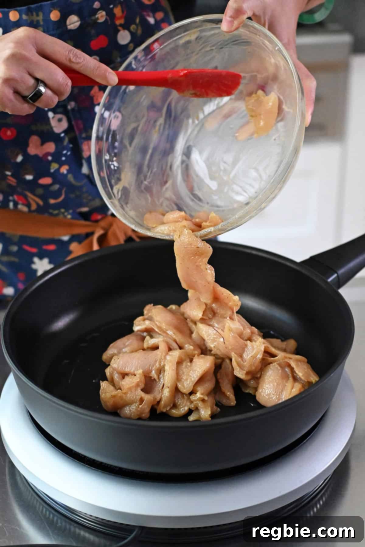 Cantonese Chicken and Mushroom Medley 12 Adding the marinated chicken breast slices to the frying pan to make moo goo gai pan.