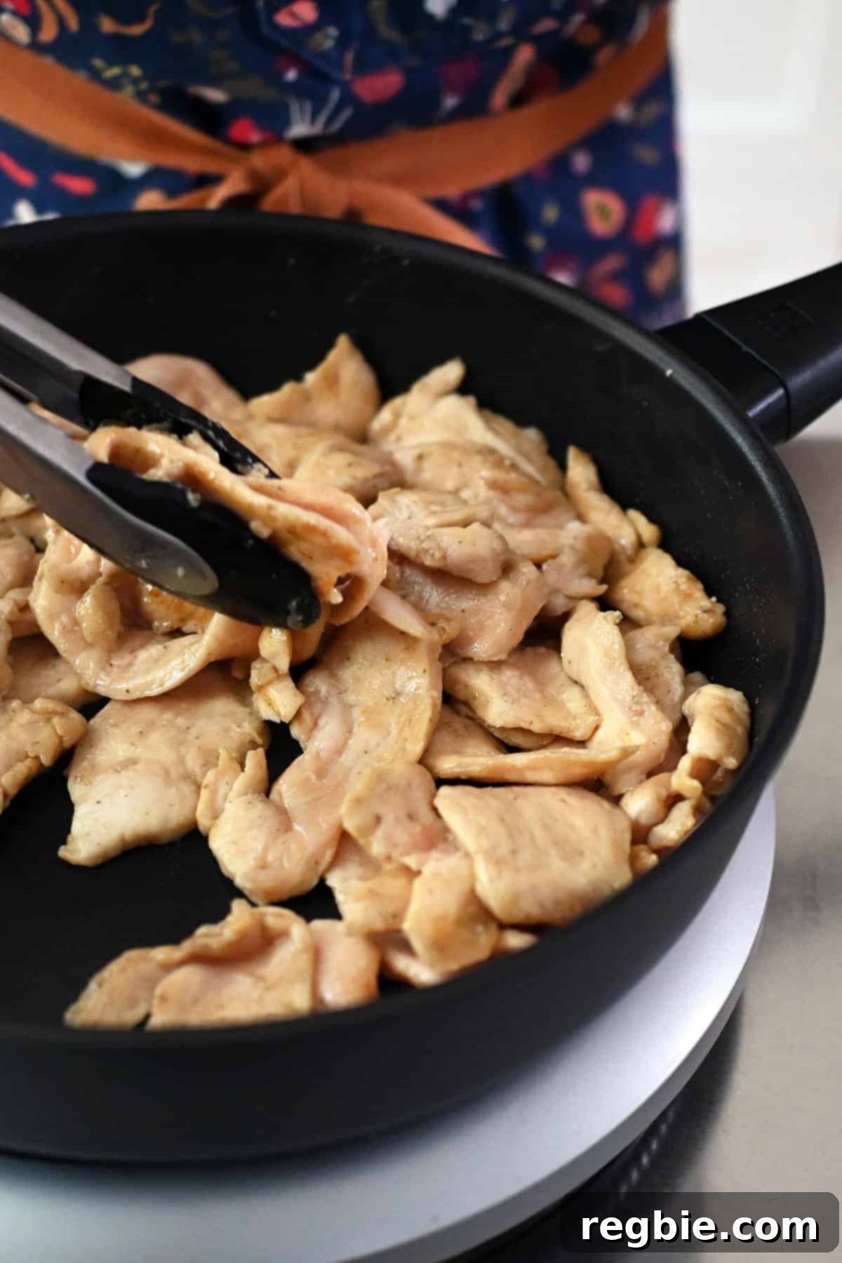 Cantonese Chicken and Mushroom Medley 13 Sautéing the chicken breast slices in the frying pan until they are no longer pink.