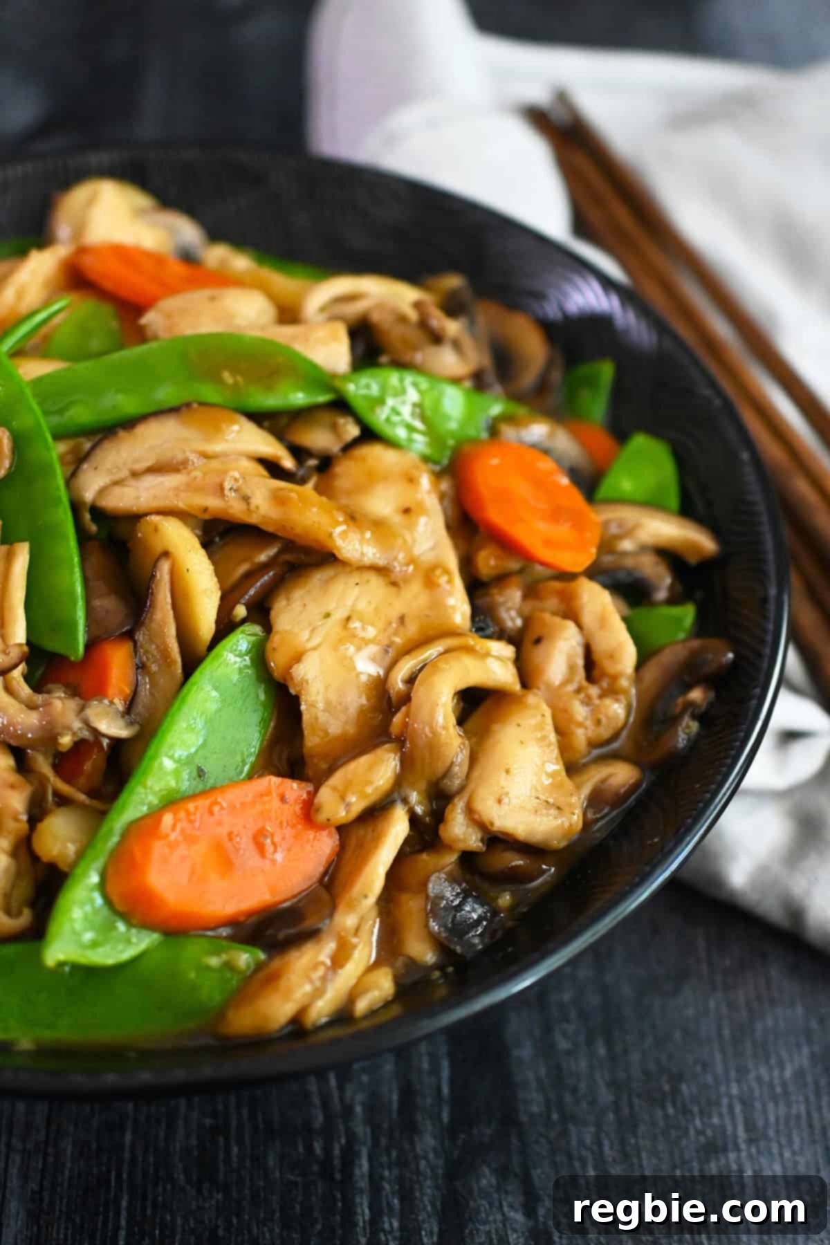 Cantonese Chicken and Mushroom Medley 4 A closeup shot of a bowl filled with homemade gluten free and paleo stir fried chicken and mushrooms, moo goo gai pan.