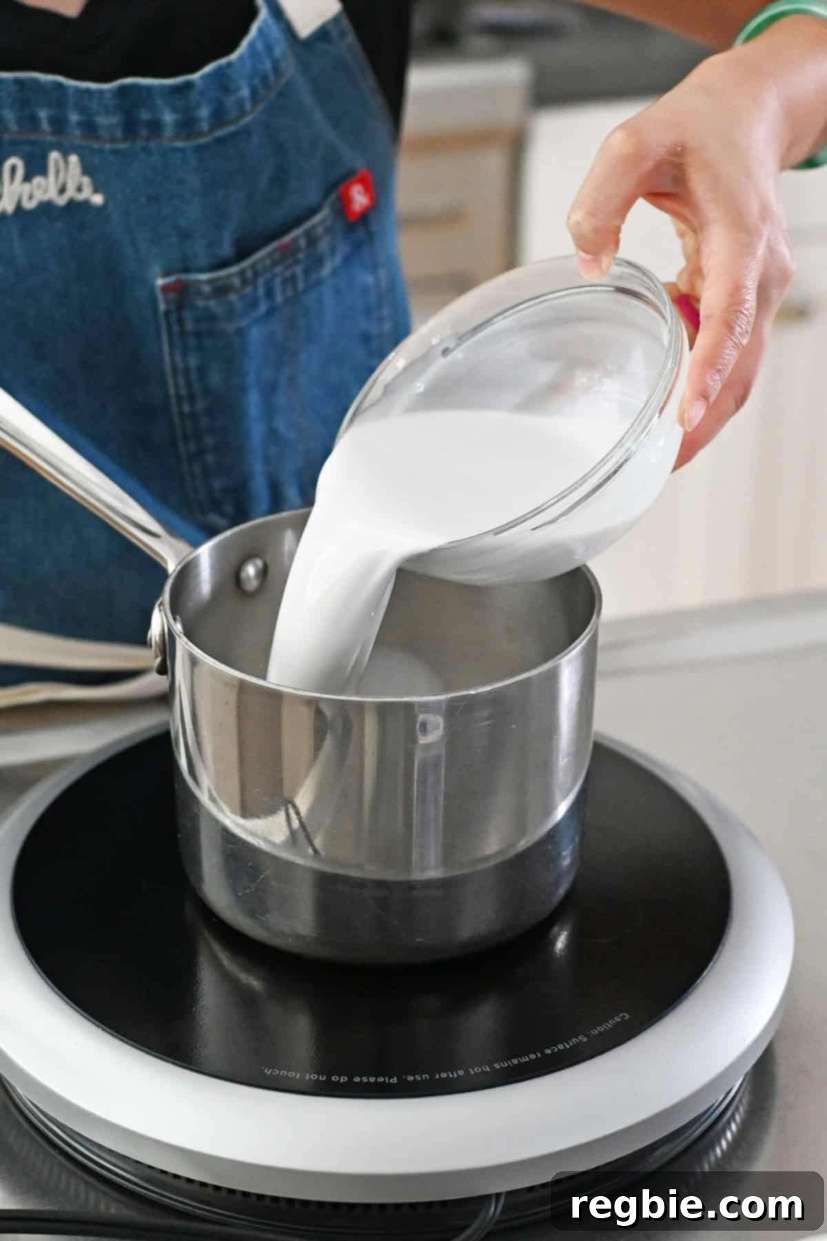 Golden Harvest Pumpkin Bars 15 Pouring coconut milk into a small saucepan to heat up.