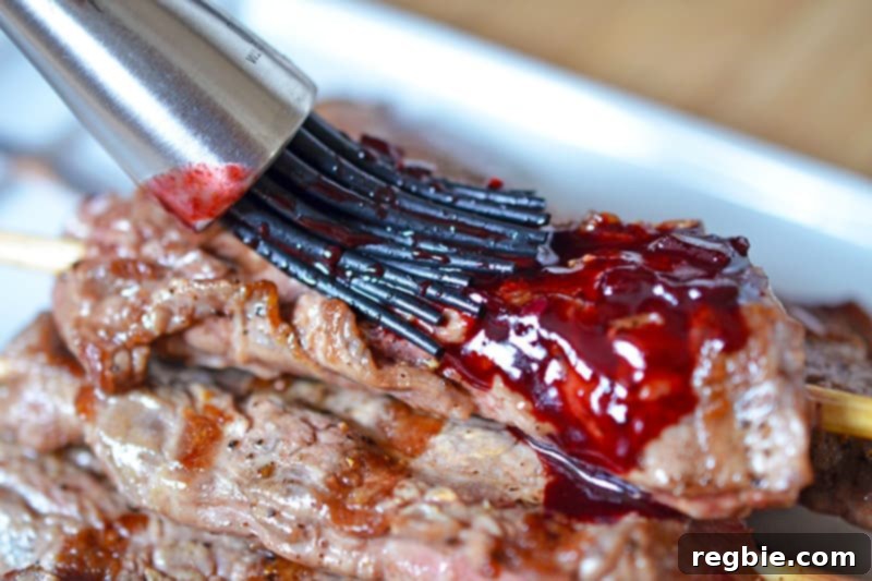 Brushing on the Whole30 cherry BBQ sauce on the steak kabobs.