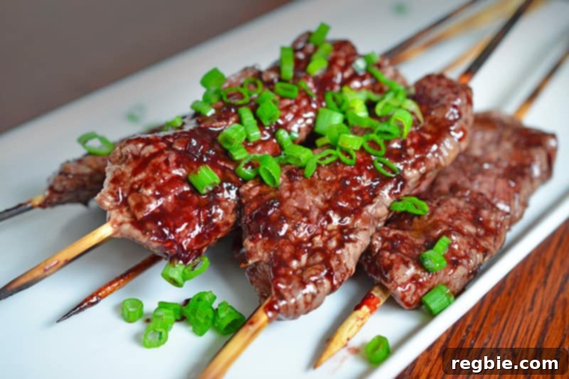 A white platter topped with Whole30 beef kabobs with paleo cherry BBQ sauce