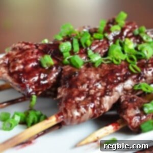 A closeup of Whole30-friendly steak skewers with cherry barbecue sauce.