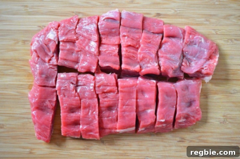 The piece of flank steak is shown cut into 16 even pieces