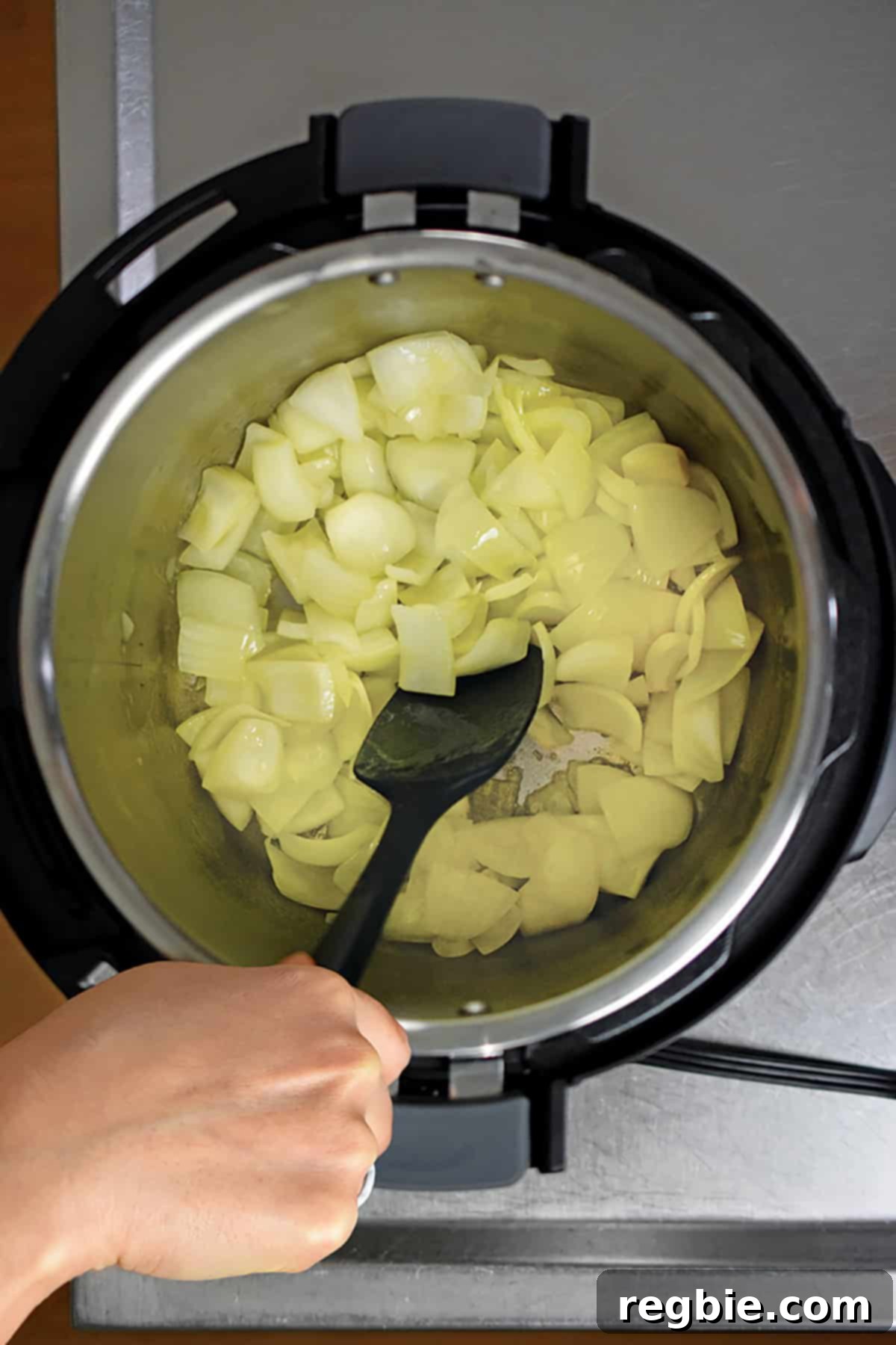 An overhead view of sautéed chopped onions in the Instant Pot, showing their softened and translucent texture.