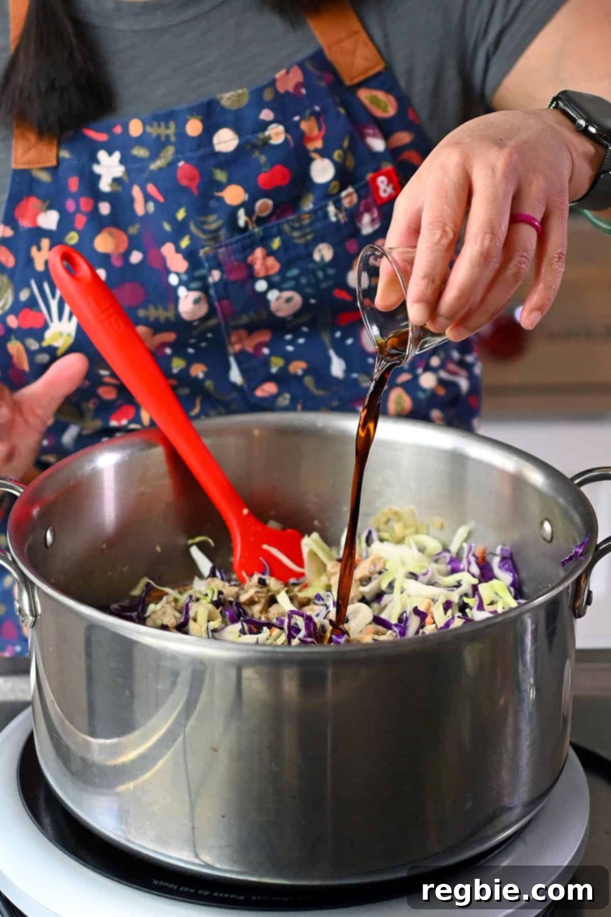 Seasoning the soup with coconut aminos and fish sauce for rich umami flavor.