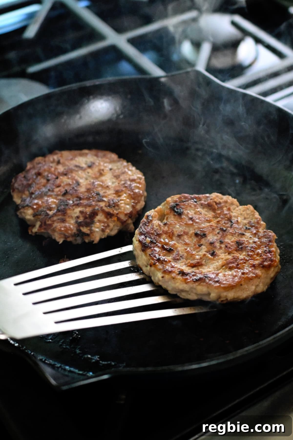 Flipping a golden brown turkey burger in a skillet.