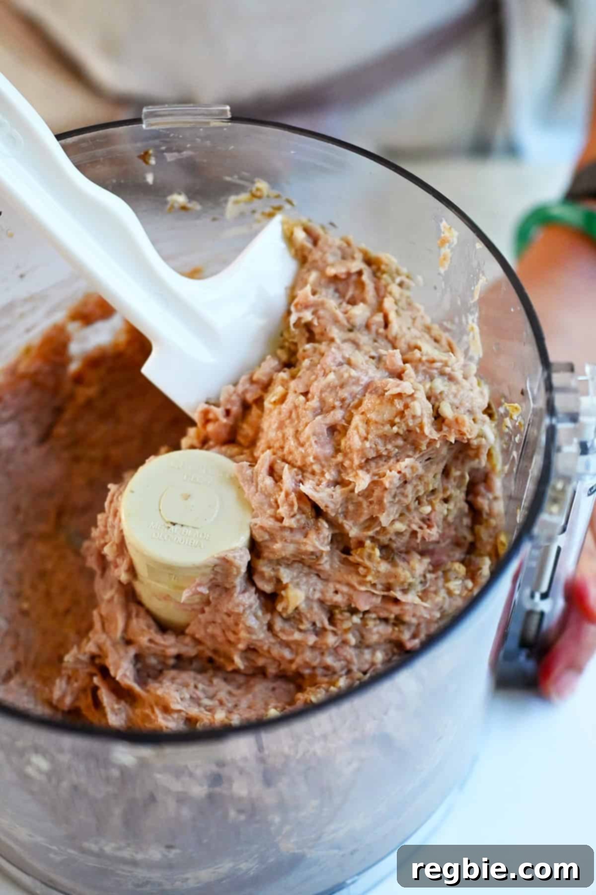 A closeup shot of the raw turkey burger mixture after it is blended in a food processor.
