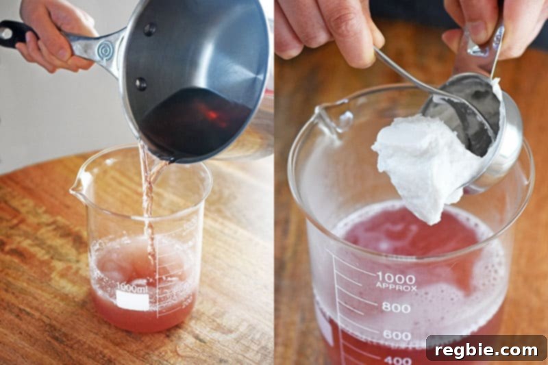 A hand adding a scoop of thick coconut cream into the warm coconut water and gelatin mixture.
