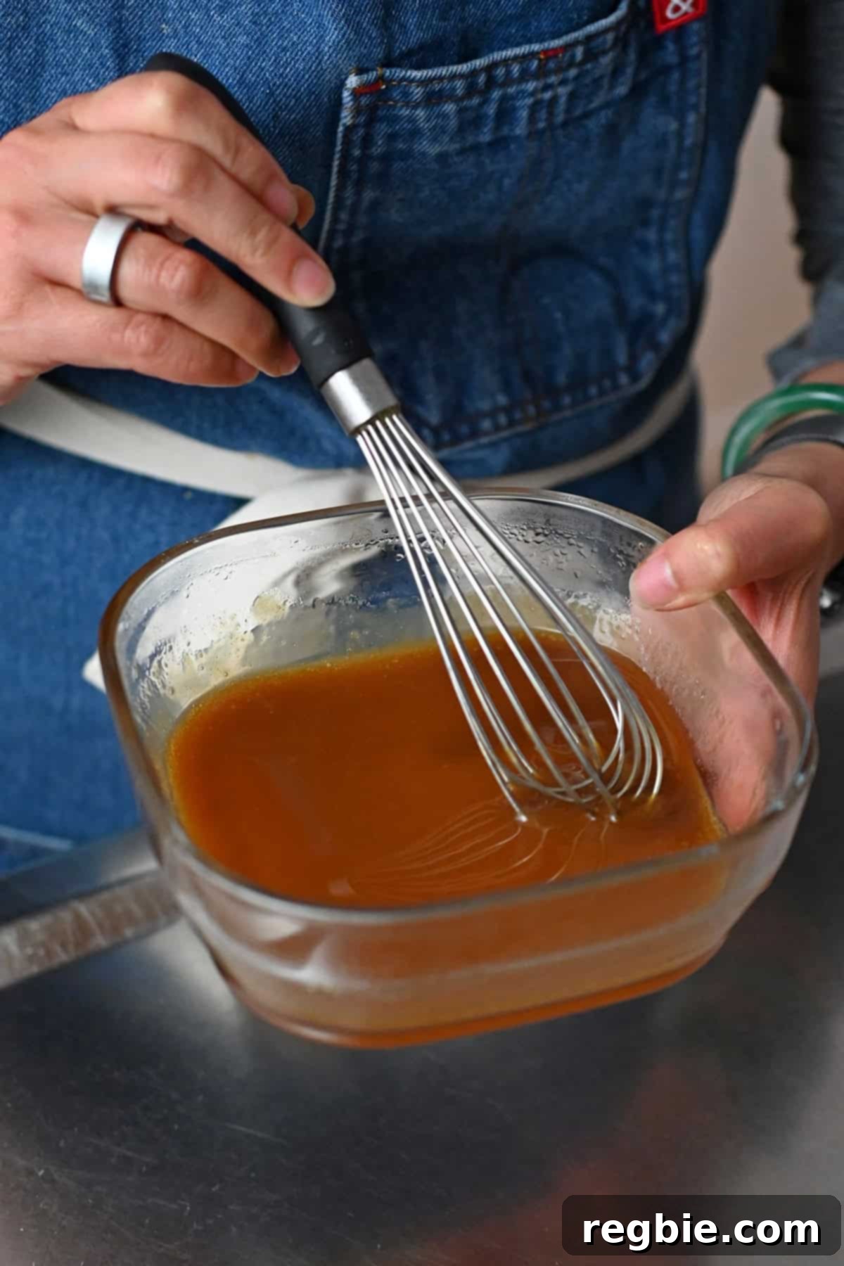 The finished maple dijon mustard glaze for the turkey meatballs after it has been heated in the microwave.