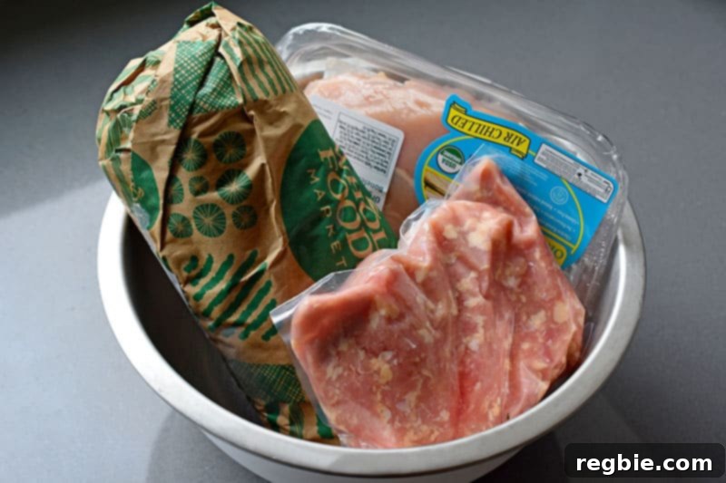 One Pan Beef Cabbage Wonder 4 A robust metal bowl brimming with various packages of frozen meat, diligently thawing in a refrigerator – a practical and essential tool for efficient meal planning and prep, known as Nom Nom Paleo's defrost bowl.