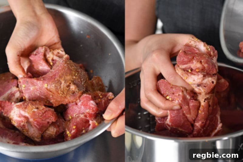 A close-up shot of seasoned pork cubes being tossed in a bowl, ensuring an even coating of spices before being transferred to the Instant Pot.