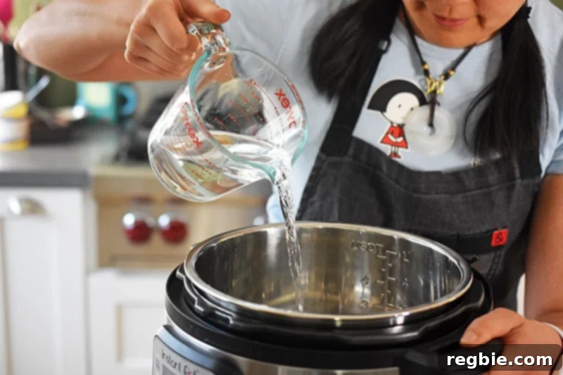 Perfect Instant Pot Beets 5 Someone pouring water into an instant pot for instant pot beets.