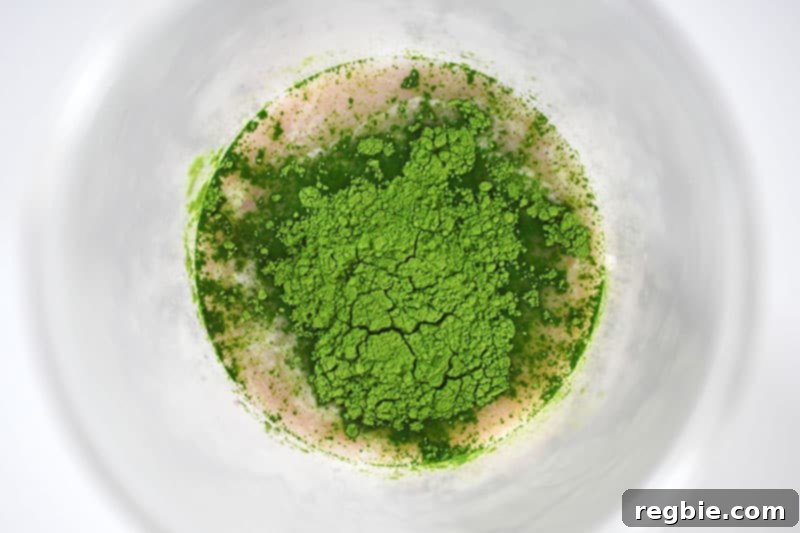 Refreshingly Cool Whole30 Dairy-Free Iced Matcha Latte 8 An overhead shot showing all the ingredients for Iced Matcha Latte (coconut water, collagen, creamer, matcha) collected in a blending cup.