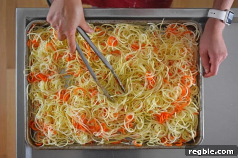 An overhead shot of the swoodles in a rimmed baking sheet, ready to go in the oven.