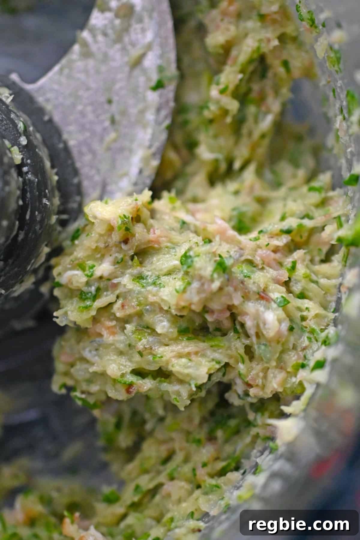 A close-up shot of the shrimp filling after being pulsed in a food processor, displaying its ideal coarse, chunky, and sticky texture.
