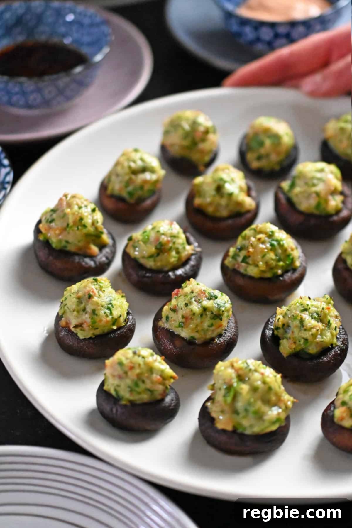 A delicious close-up of a single, perfectly finished shrimp stuffed mushroom, ready to be picked up and enjoyed.