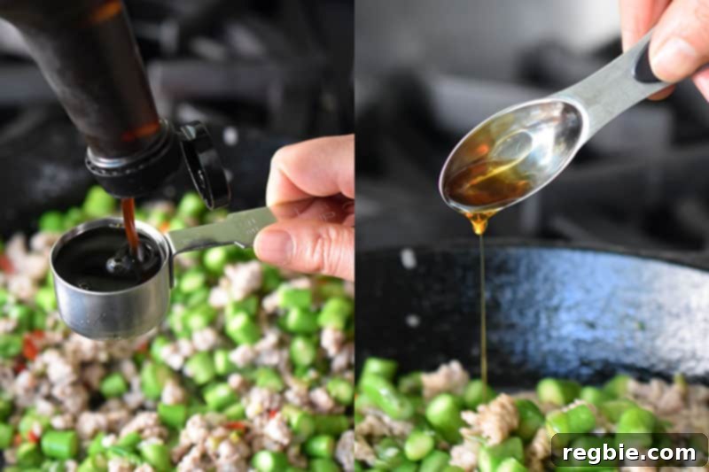 Pouring in the seasoning for Spicy Pork and Asparagus Stir-Fry.