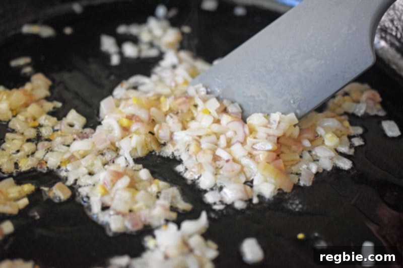 Stir-frying the diced shallots until softened.