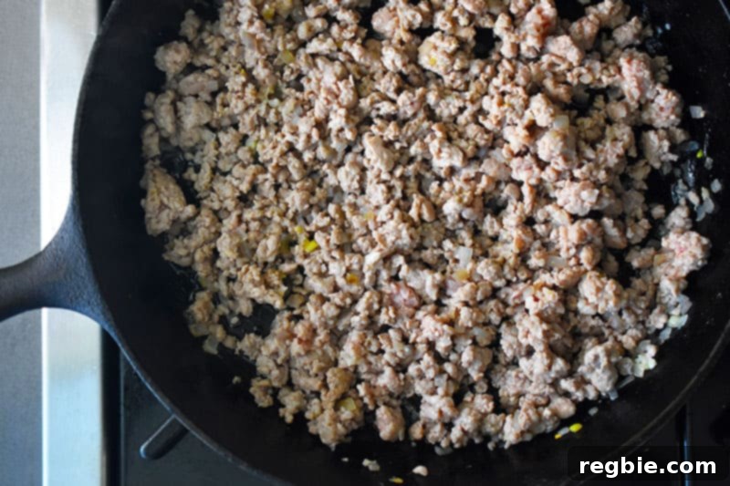 An overhead shot of the cooked ground pork in a skillet.