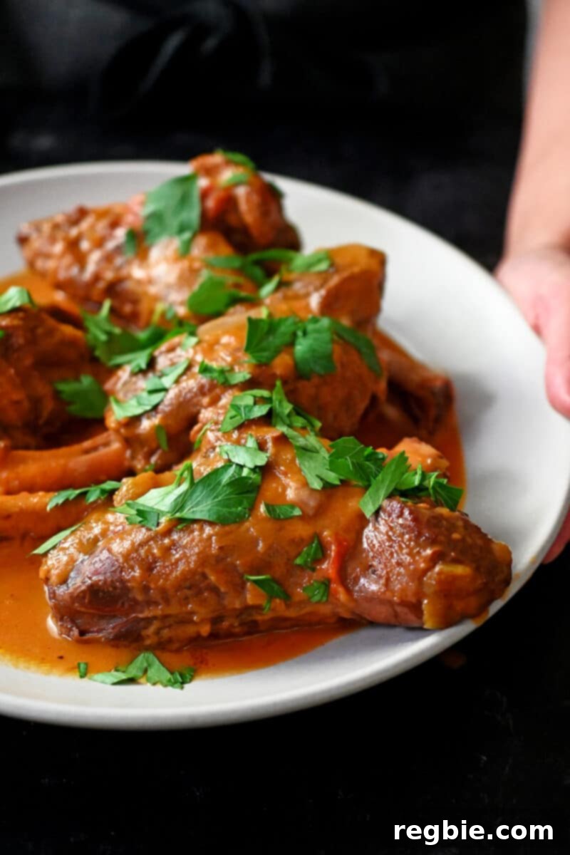 Side view of braised lamb shanks cooked in an Instant Pot.