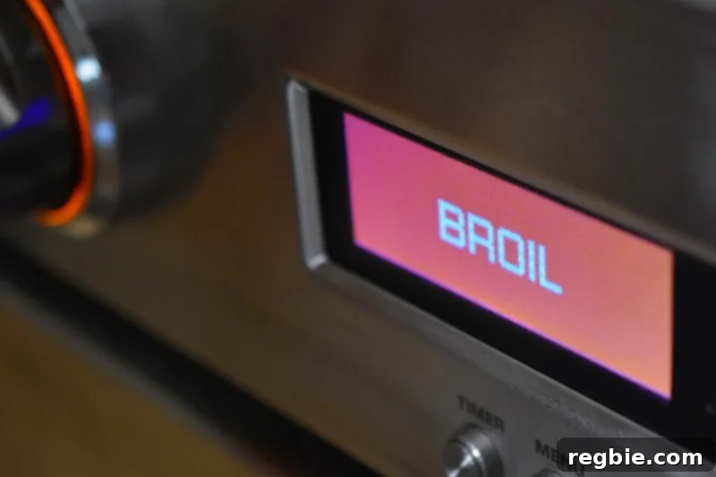 The oven display shows the function switched to Broil, indicating the next cooking phase for Sheet Pan Chicken Fajitas.