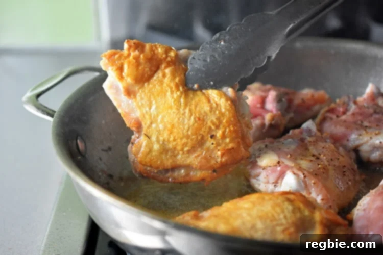 Golden-Crisp Cantonese Chicken Thighs 13 Flipping over Cantonese Crispy Chicken Thighs to cook on the meaty side.